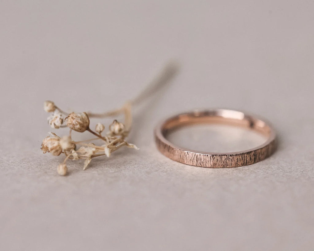 Front view of handmade rose gold horn texture ring with dried flowers