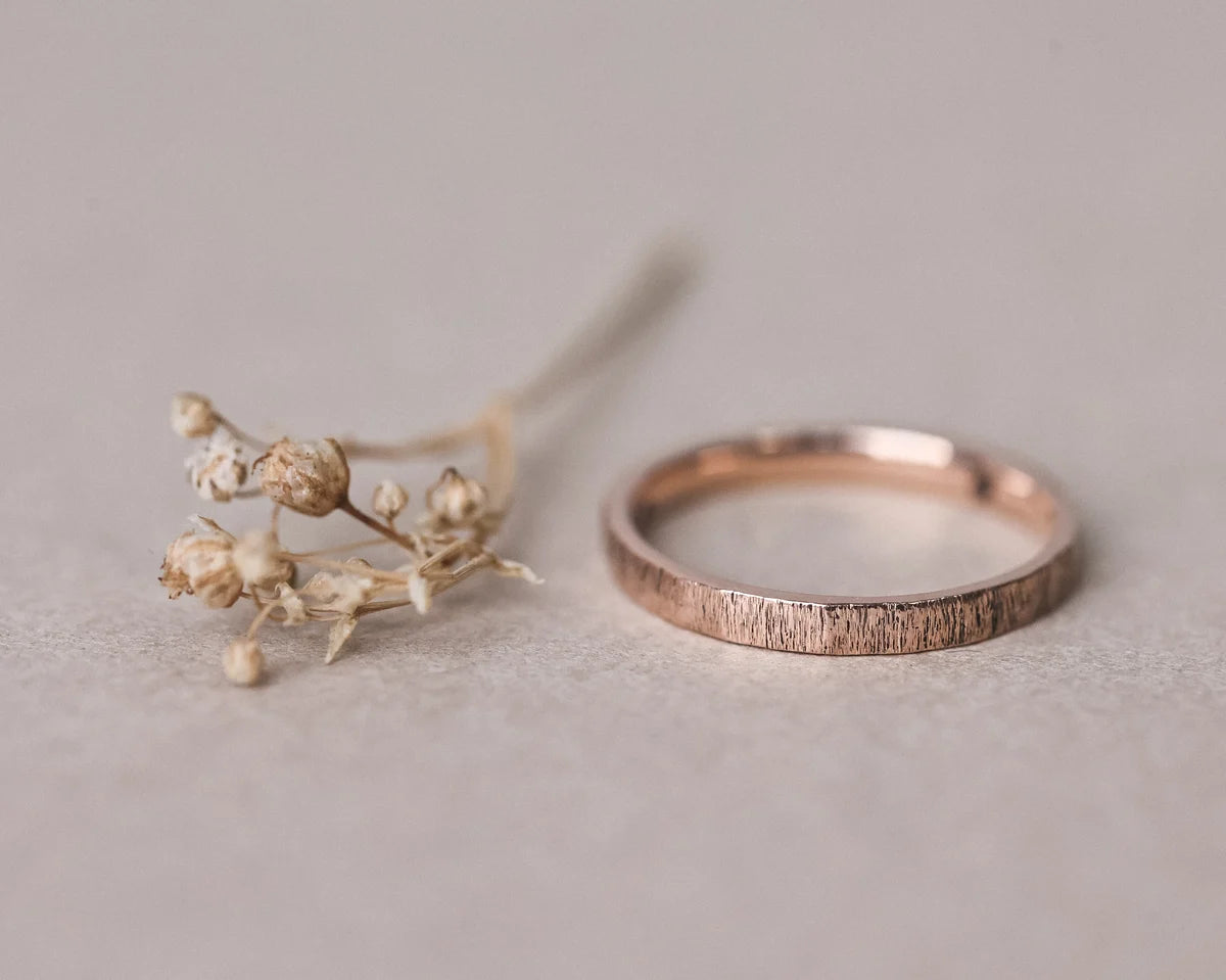 Front view of handmade rose gold horn texture ring with dried flowers