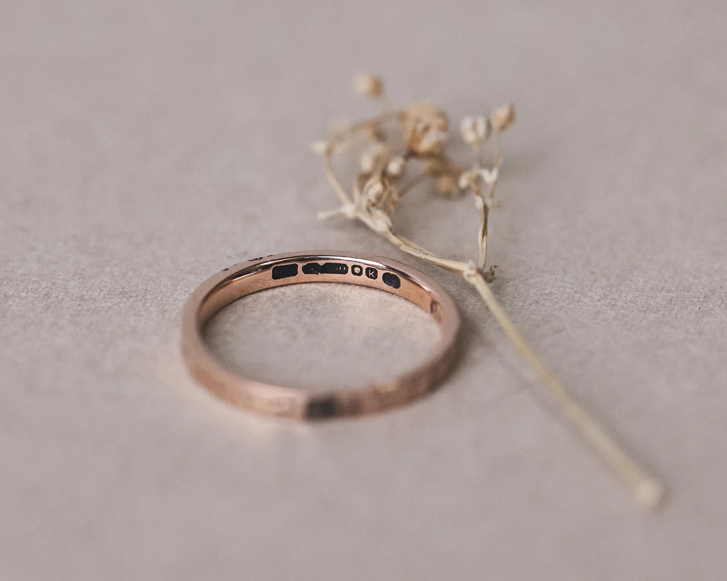 Inside view of 18ct rose gold flat court wedding ring with hallmark