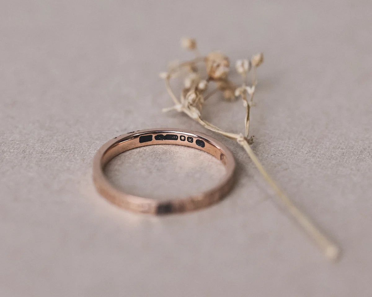 Inside view of 18ct rose gold flat court wedding ring with hallmark