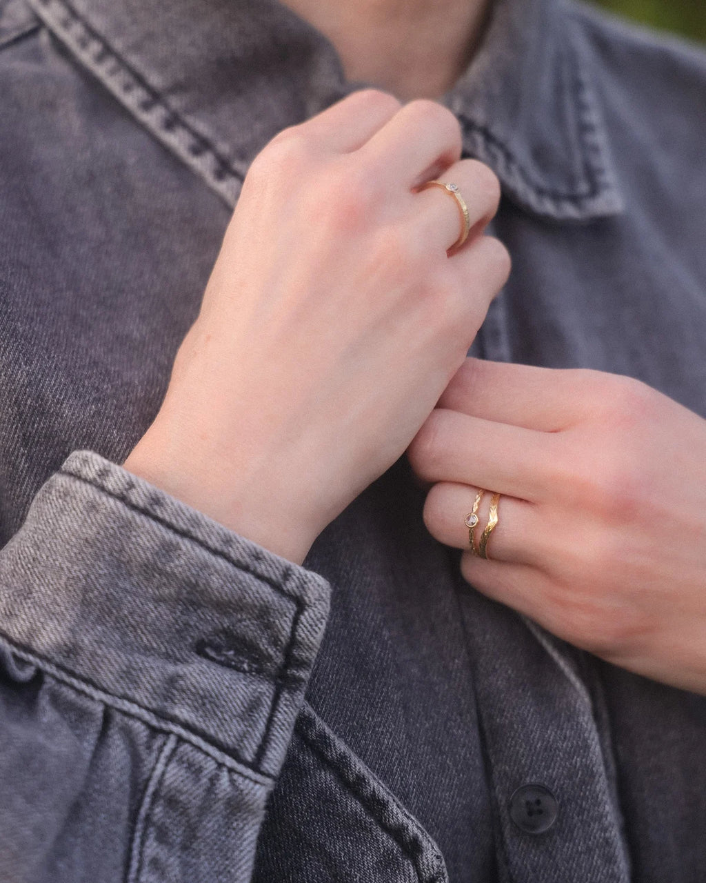 Rose-cut diamond laurel leaf ring worn with denim shirt