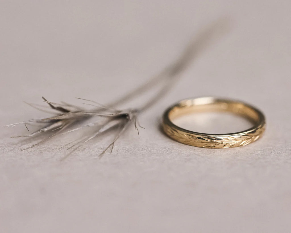 Front view of 18ct yellow gold olive leaf engraved wedding ring