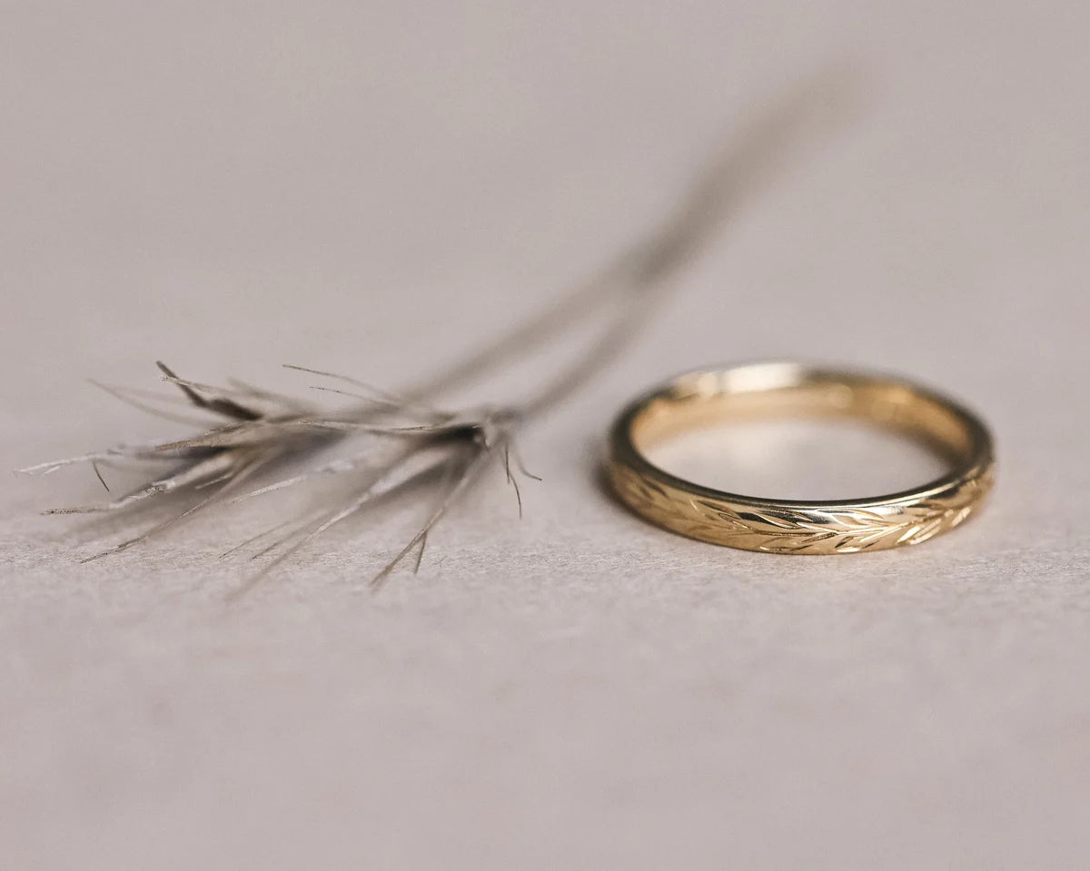 Front view of 18ct yellow gold olive leaf engraved wedding ring