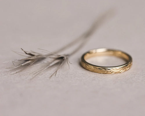 Front view of 18ct yellow gold olive leaf engraved wedding ring