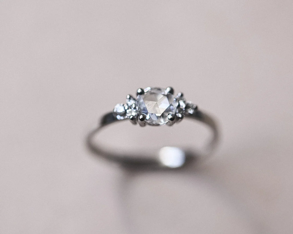 Side view of 5mm rose-cut diamond ring with diamond shoulders in platinum