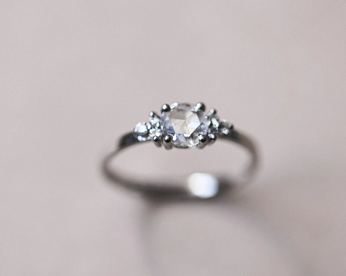 Side view of 5mm rose-cut diamond ring with diamond shoulders in platinum