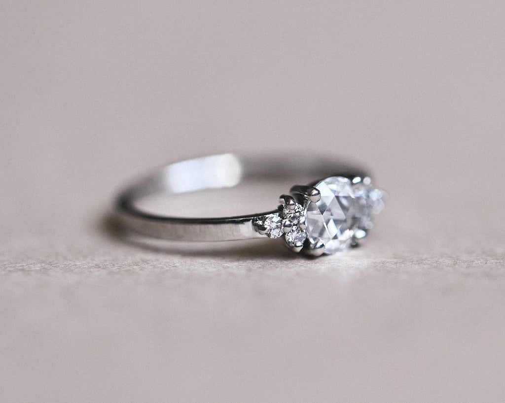 Low side view of rose-cut diamond ring with plain platinum band