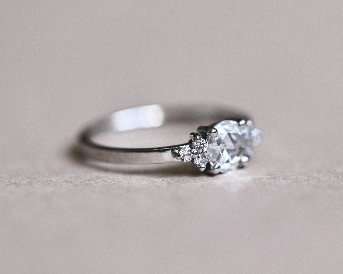Low side view of rose-cut diamond ring with plain platinum band