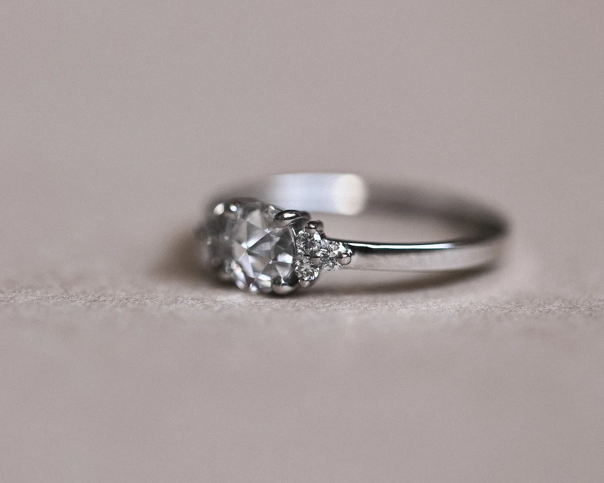 Close-up of 5mm rose-cut diamond ring with brilliant-cut diamond shoulders