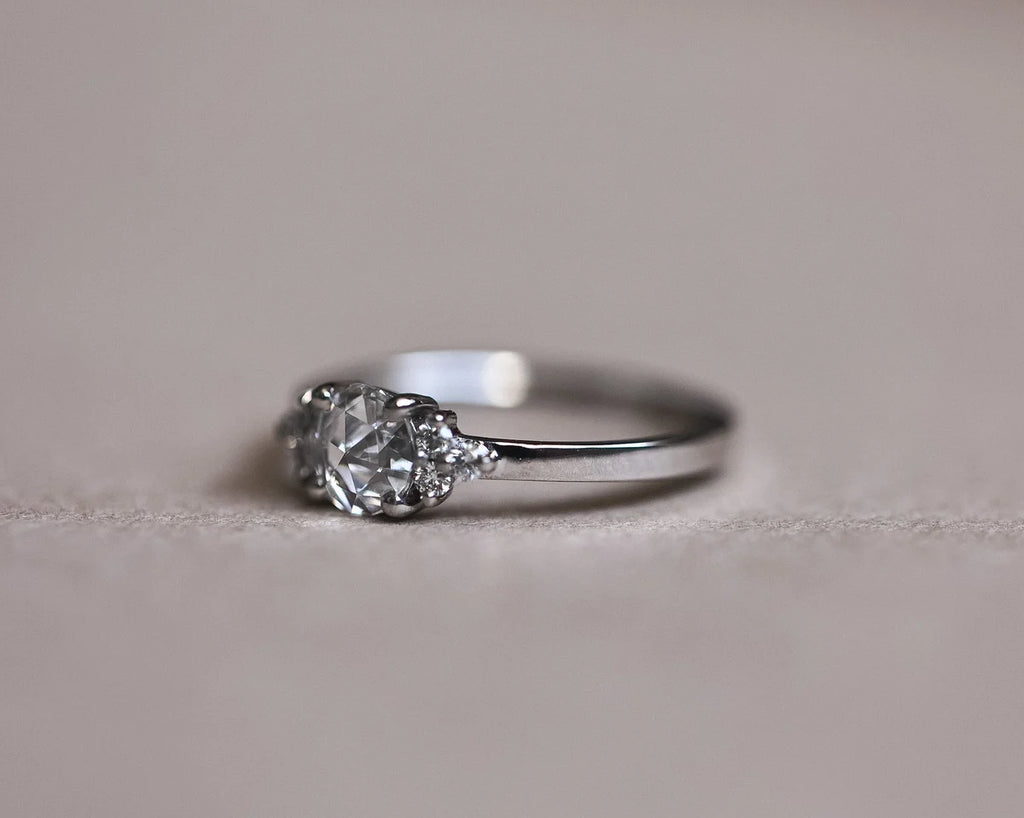 Portrait view of platinum engagement ring with rose-cut centre diamond