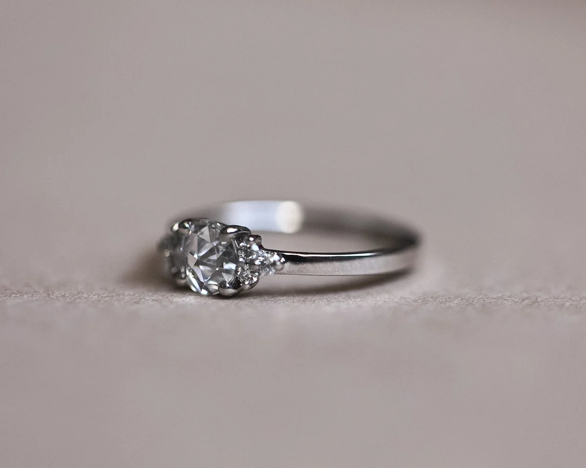 Portrait view of platinum engagement ring with rose-cut centre diamond