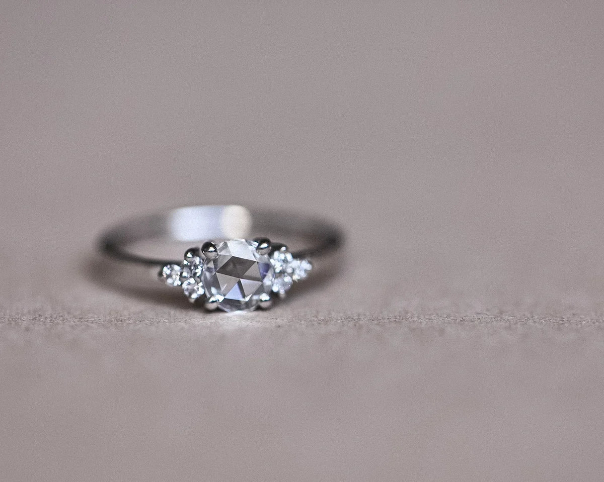 Soft focus side view of platinum rose-cut diamond ring