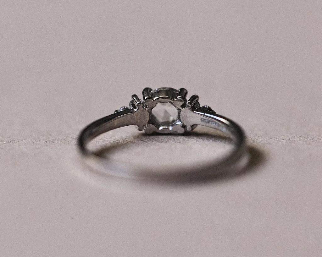 Side profile of platinum ring with rose-cut diamond and diamond shoulders
