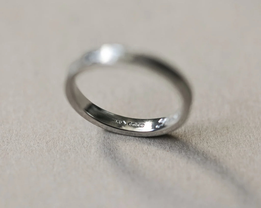 Back view of platinum flat court wedding ring with smooth interior