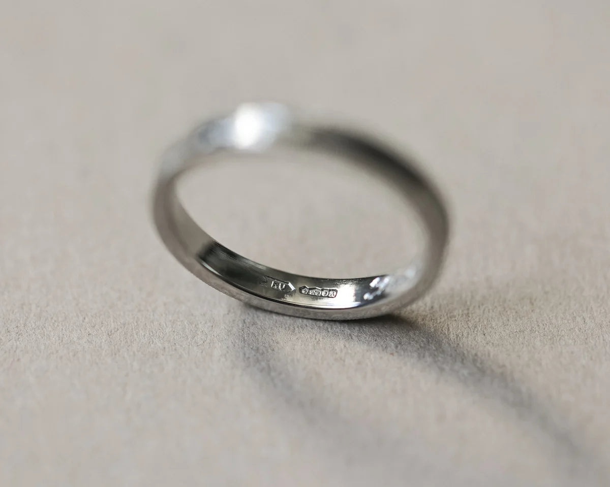 Back view of platinum flat court wedding ring with smooth interior