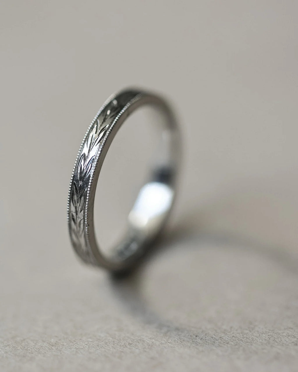 Side view of platinum olive leaf and milled edge wedding ring