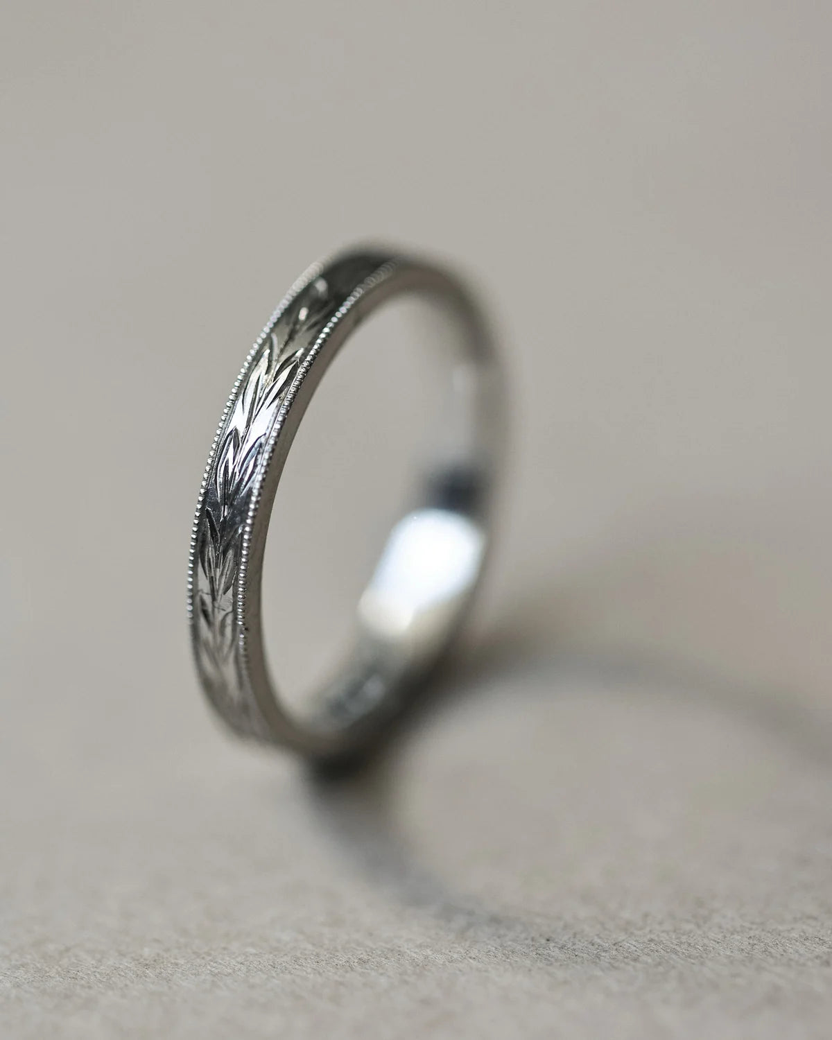 Side view of platinum olive leaf and milled edge wedding ring