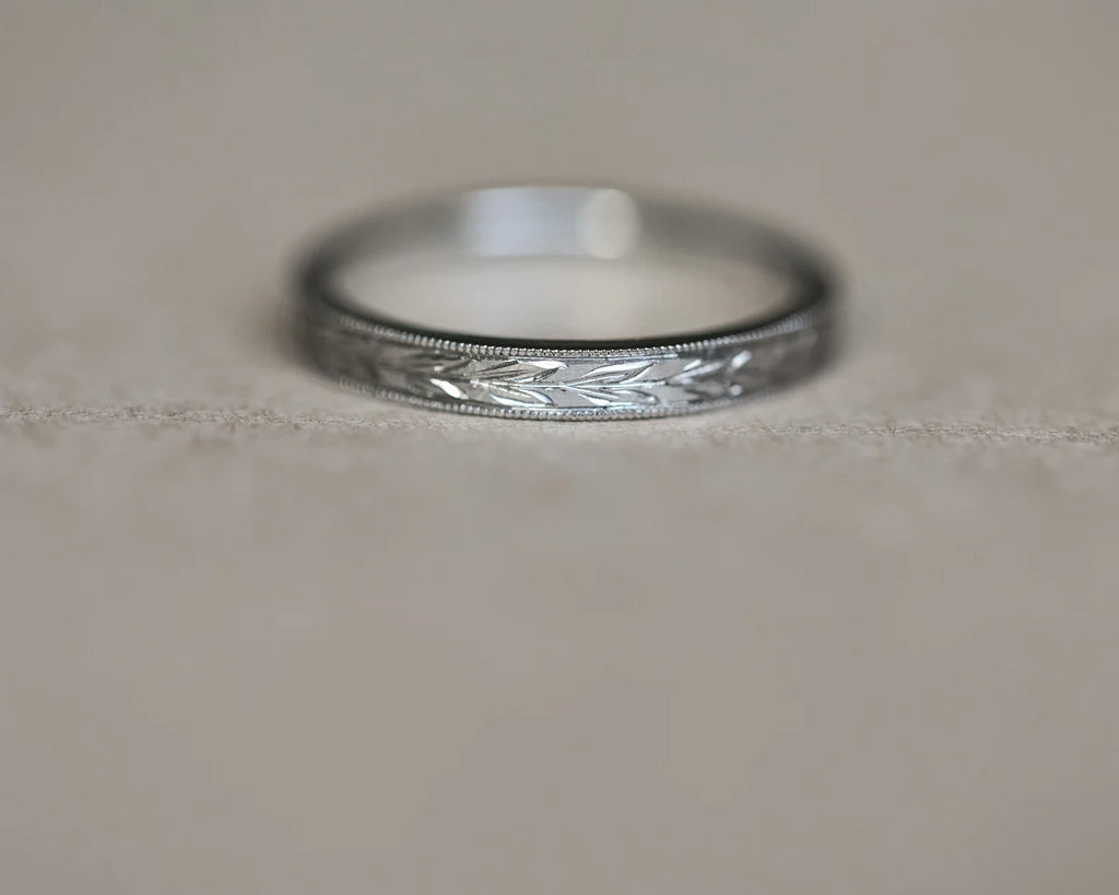 Low front view of handmade olive leaf wedding ring in platinum