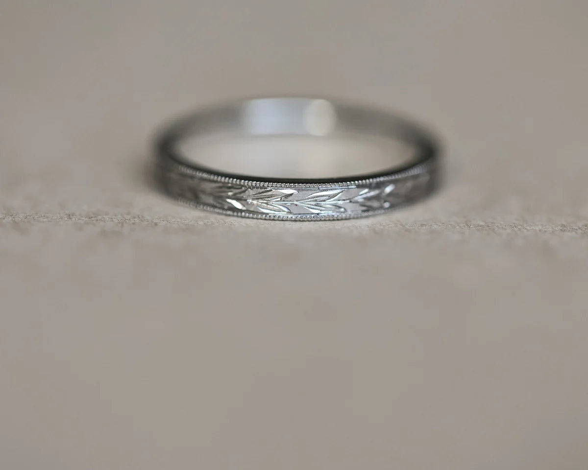 Low front view of handmade olive leaf wedding ring in platinum