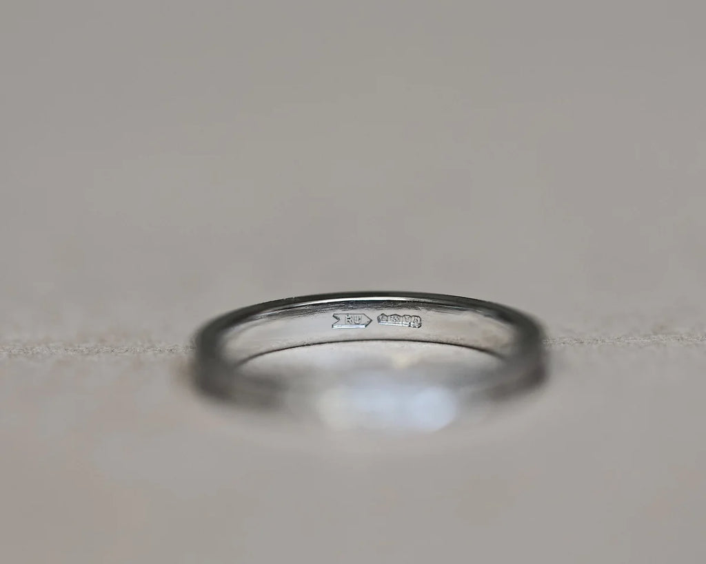 Inside view of platinum flat court wedding ring with hallmark