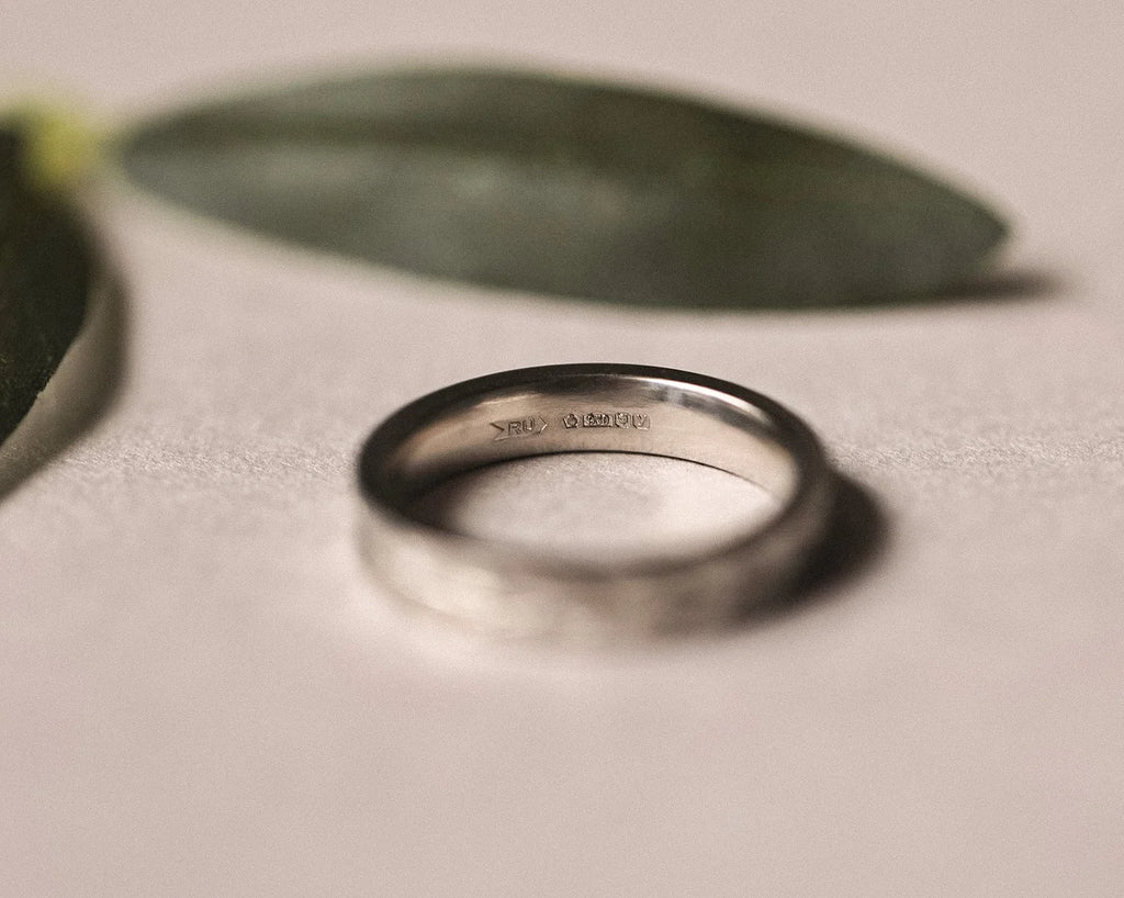 Back view of 4mm platinum wedding ring with olive leaf engraving