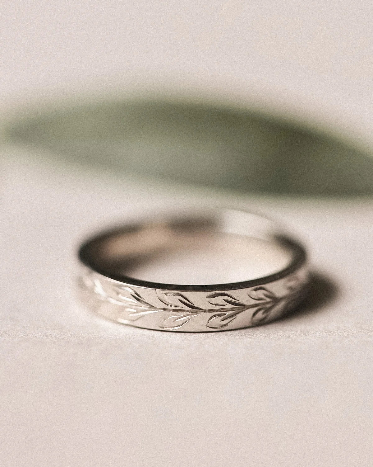 4mm olive leaf engraved flat court wedding ring in platinum with matte finish