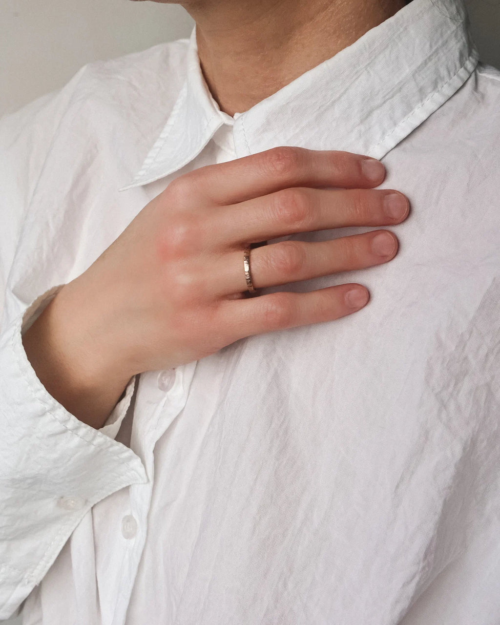 18ct rose gold horn texture ring worn on hand in natural light