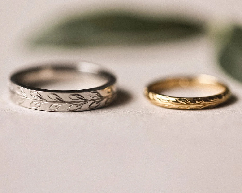 Platinum olive leaf engraved wedding ring paired with yellow gold wedding band