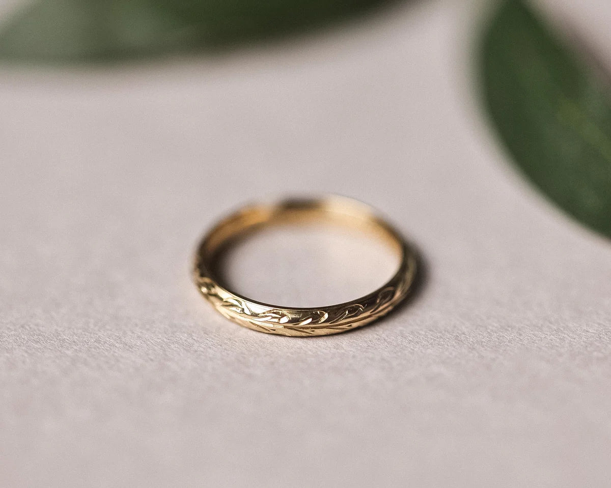 Top view of olive leaf engraved wedding ring in 9ct yellow gold