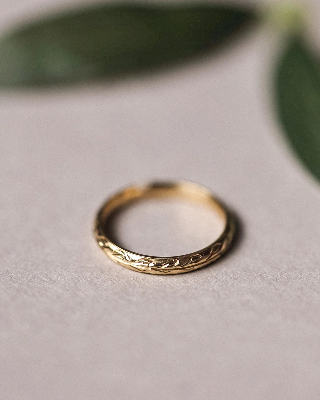 Minimal 3mm yellow gold wedding band with olive leaf engraving