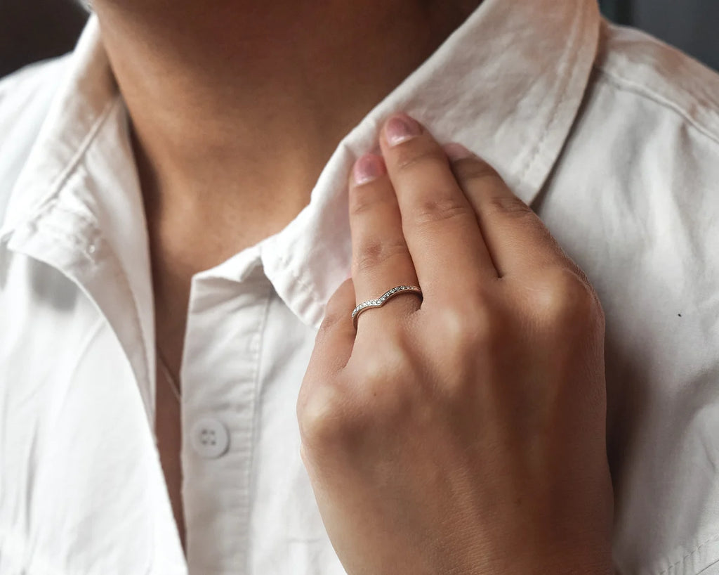 diamond wishbone ring worn with engagement ring platinum stack