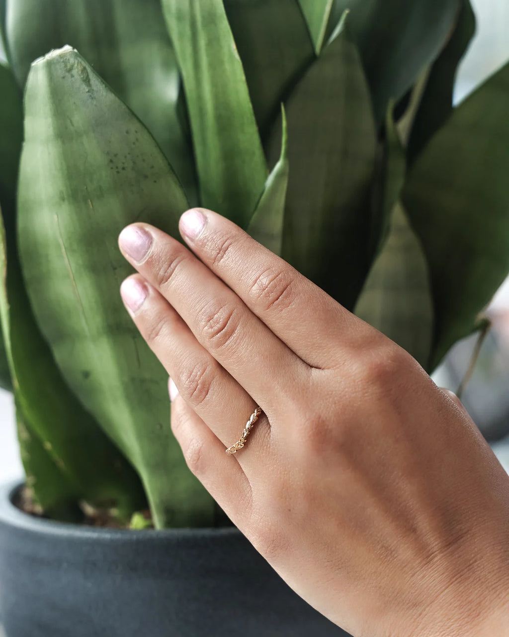 rose gold laurel leaf engraved ring worn on hand wishbone band