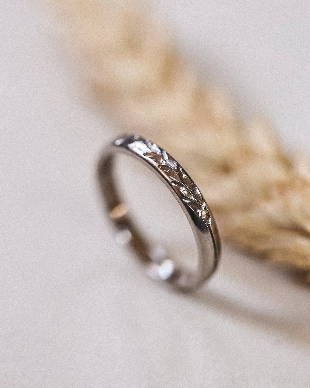 Close-up of Barleycorn engraved ring in 18ct white gold