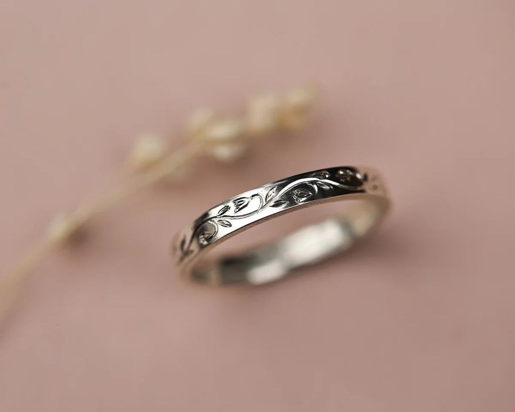Angled view of handmade snowdrop engraved ring in platinum