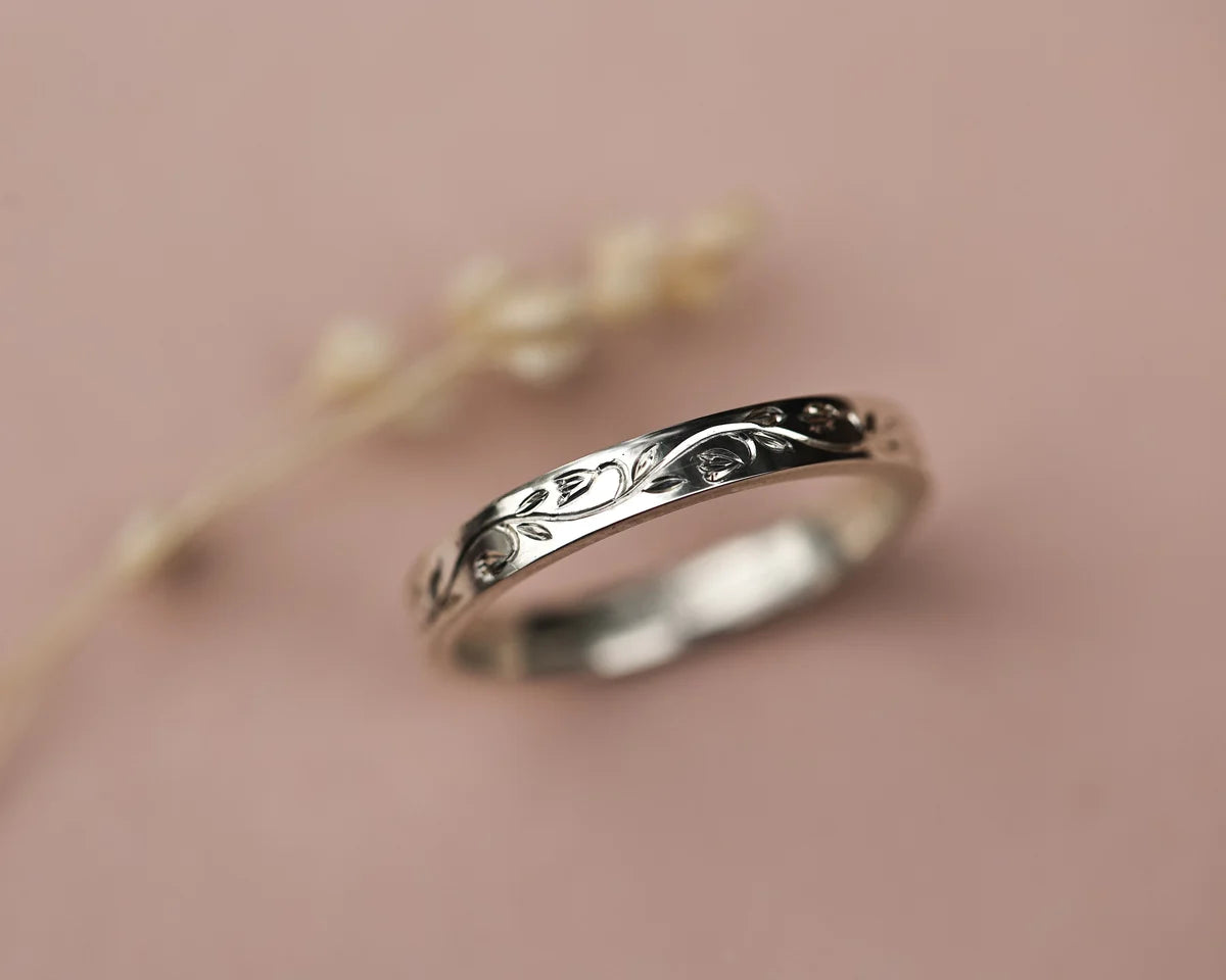 Angled view of handmade snowdrop engraved ring in platinum