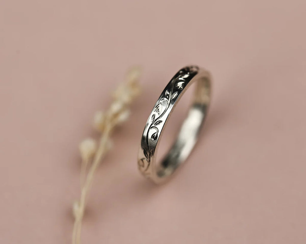 Side view of 3mm platinum flat court ring with snowdrop engraving