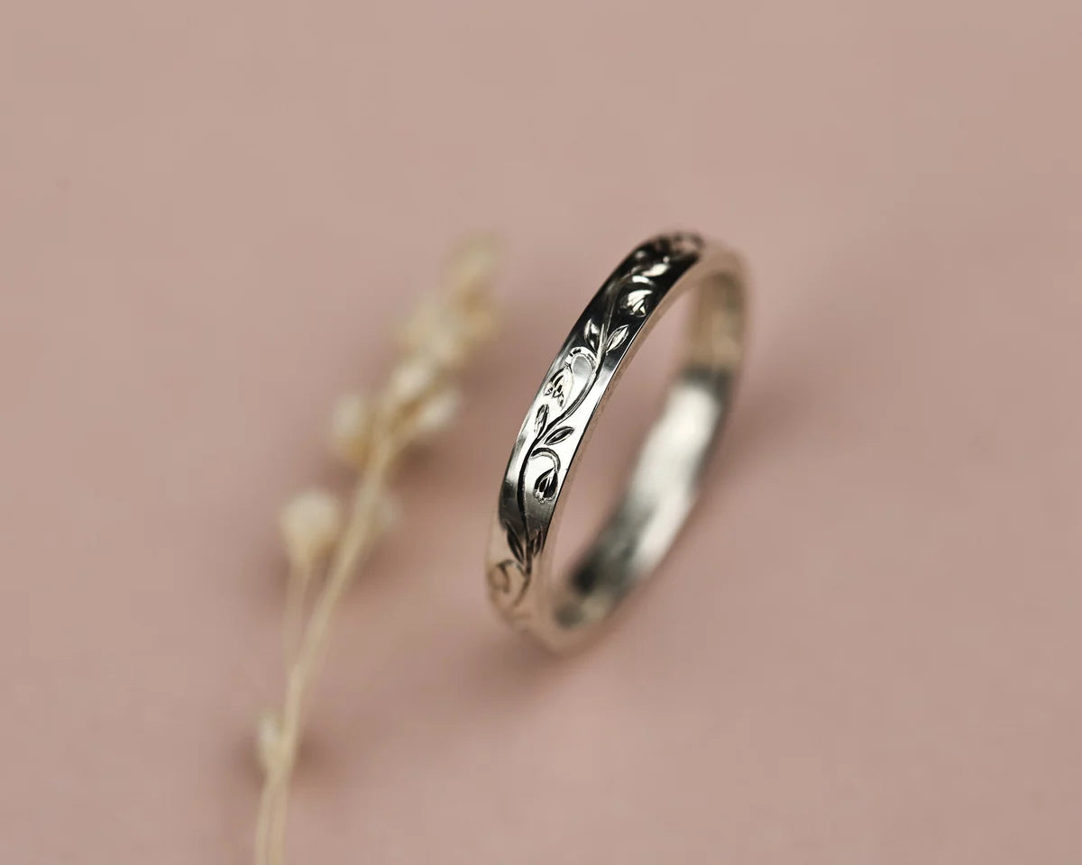 Side view of 3mm platinum flat court ring with snowdrop engraving