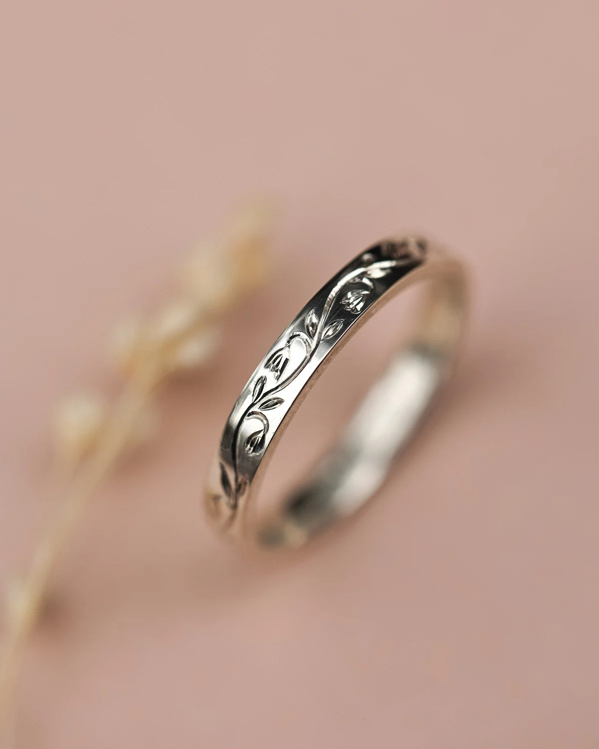 Vertical view of platinum snowdrop engraved wedding ring