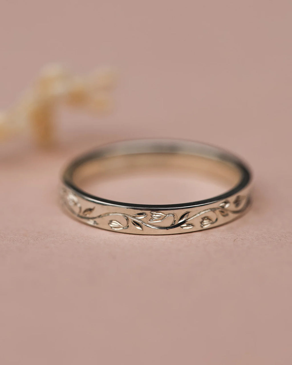 Front view of platinum snowdrop engraved wedding ring