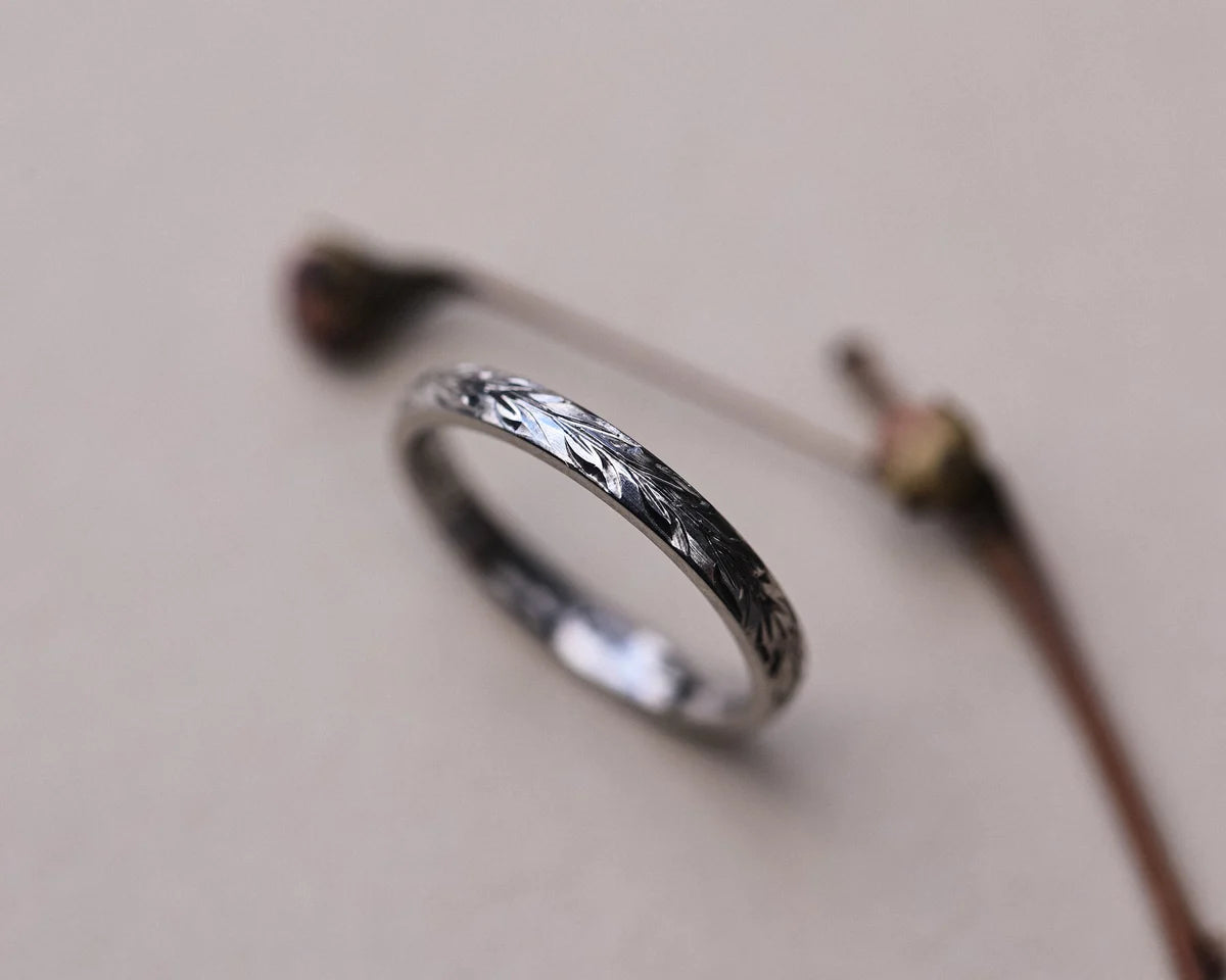 Side profile of platinum olive leaf wedding ring with botanical styling