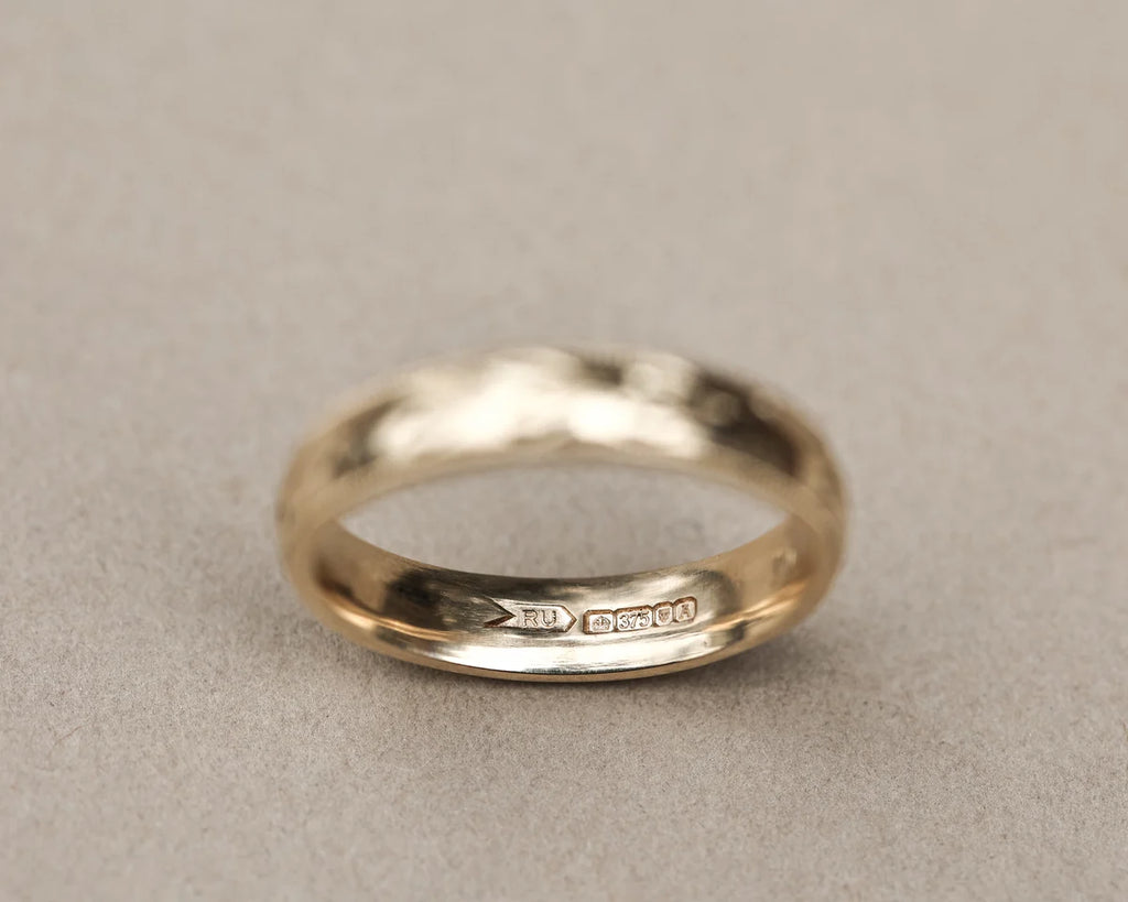 Inside view of 9ct yellow gold wedding ring with hallmark