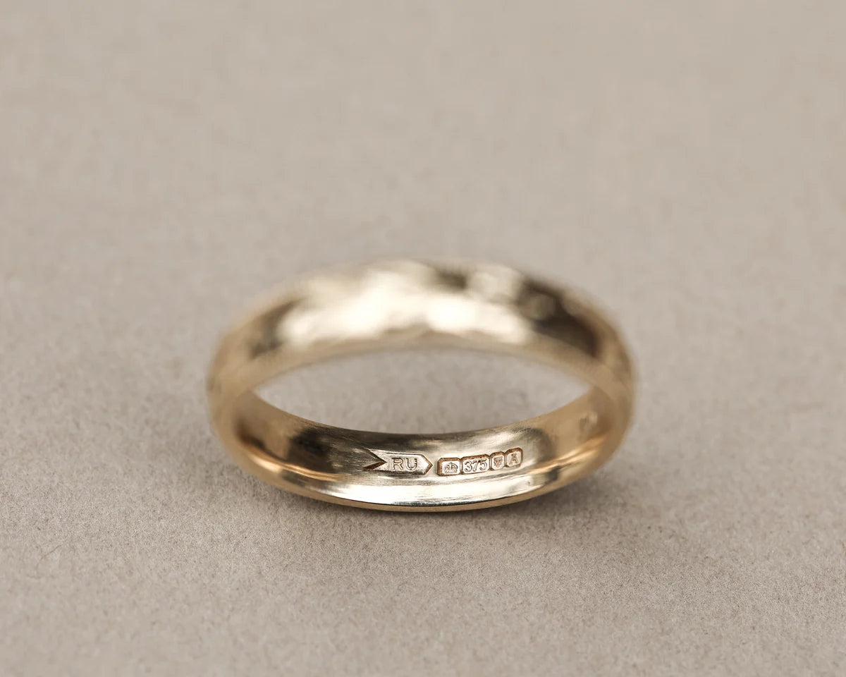 Inside view of 9ct yellow gold wedding ring with hallmark