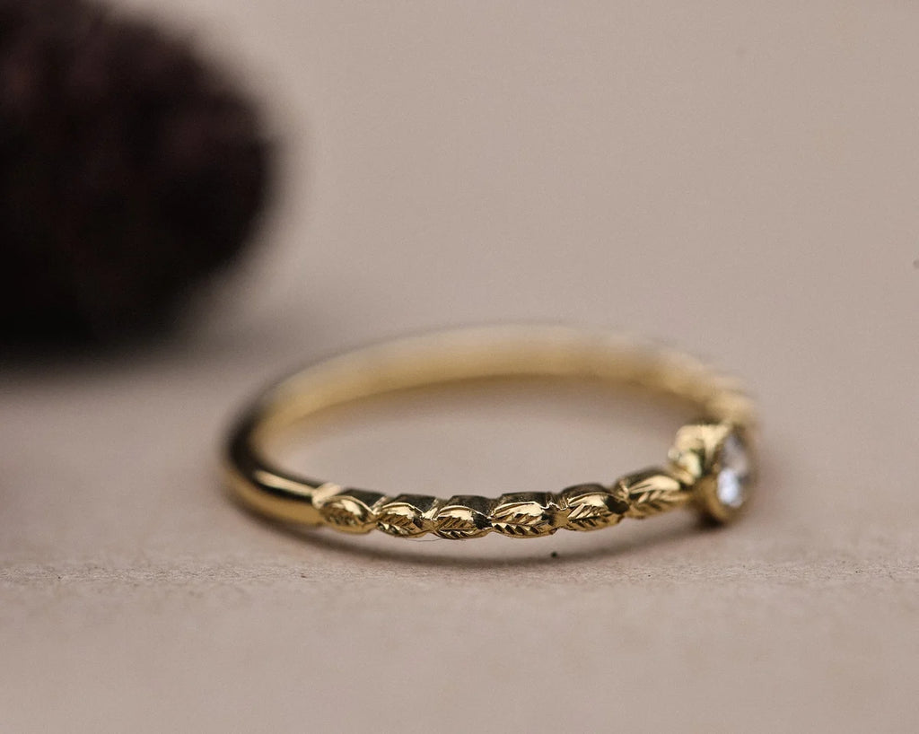 Side view of hand carved laurel leaf band in 18ct yellow gold