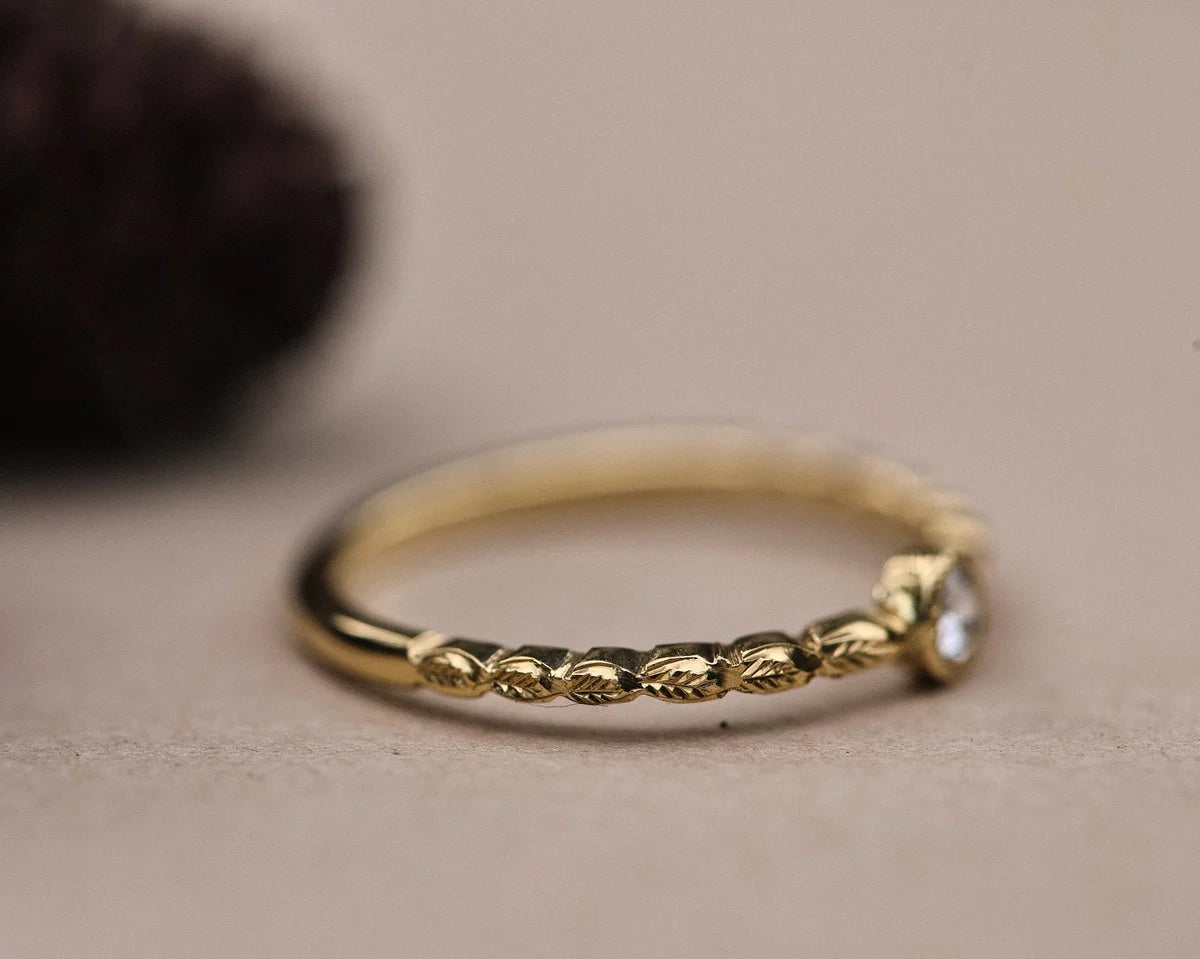 Side view of hand carved laurel leaf band in 18ct yellow gold