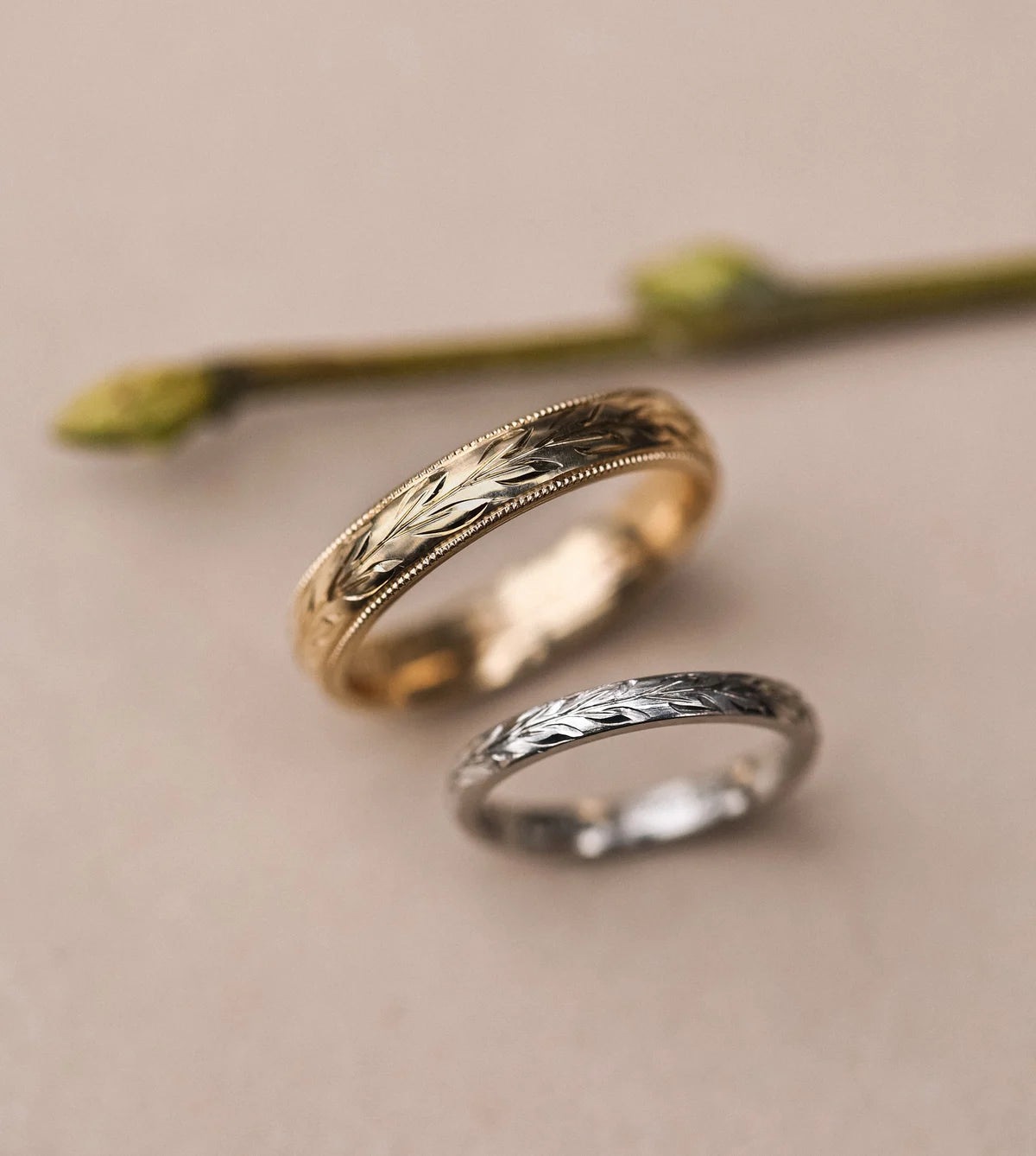 Platinum olive leaf engraved ring paired with yellow gold wedding band
