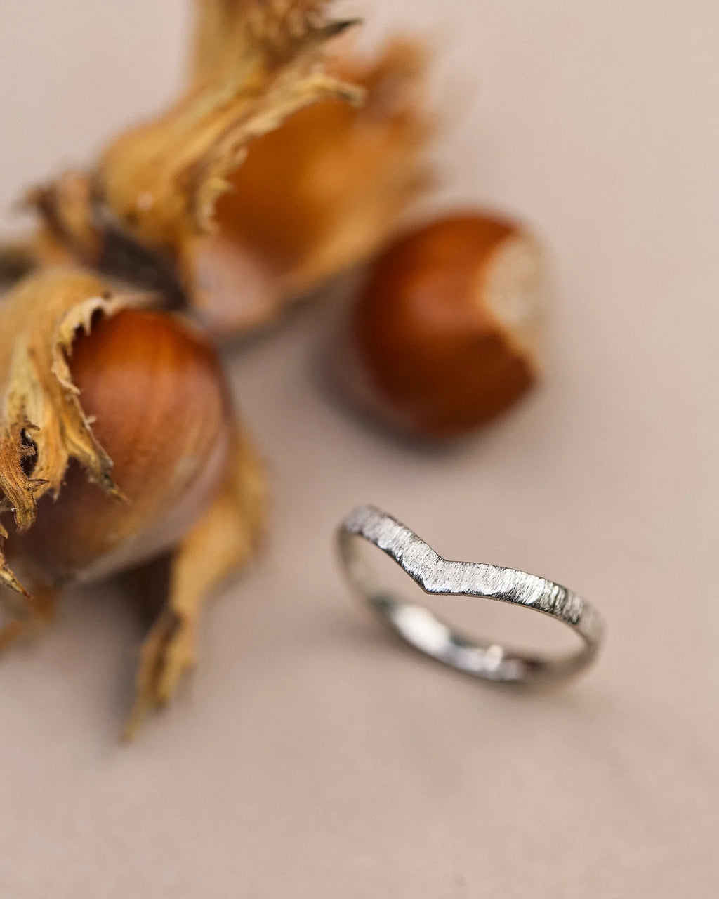 Vertical view of platinum horn texture wishbone ring