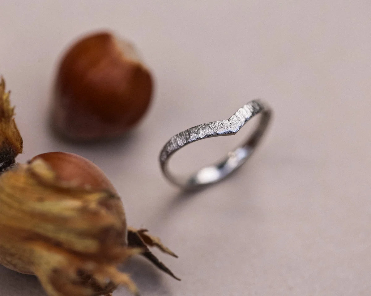 Angled view of handmade horn texture wishbone ring in platinum