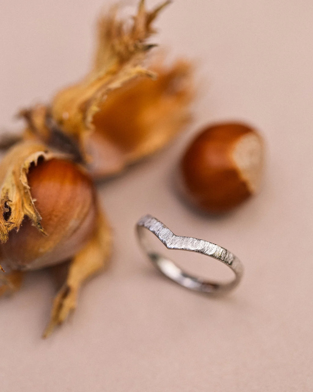 Side view of platinum wishbone ring with hand finished horn texture