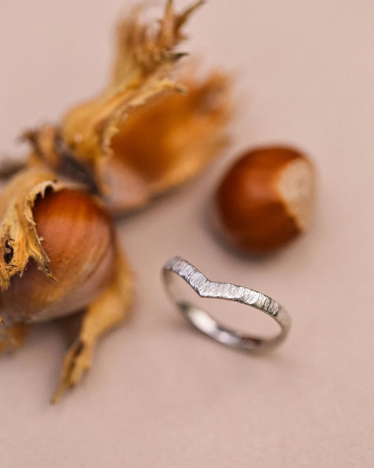 Side view of platinum wishbone ring with hand finished horn texture