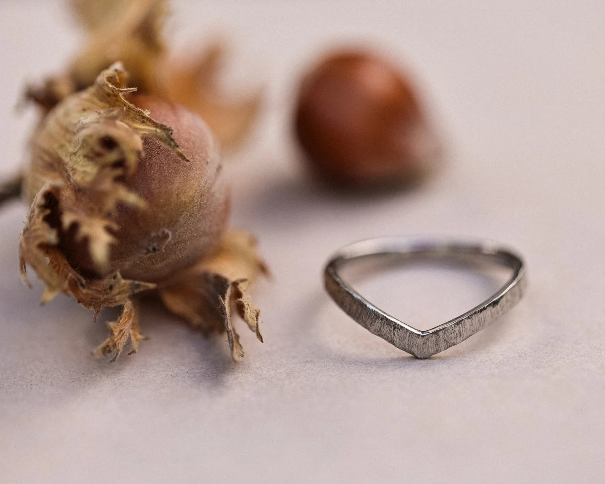 Front view of platinum horn texture wishbone ring with autumn botanical styling